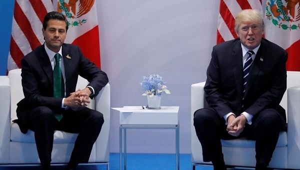 Mexican President Enrique Peña Nieto (L) has postponed plans for his first visit to U.S. President Donald Trump's White House after a testy phone call.