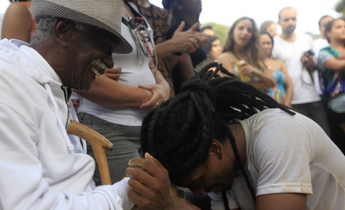A man greets Manoel Seabra, 94, a descendant of African slaves, during a Afro-Brazilian culture celebration marking .the anniversary of the abolition of slavery in Brazil.