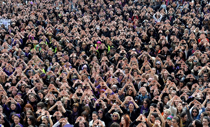 Protesters form triangles with their hands during a demonstration for women's rights in Bilbao, Spain, March 8, 2018, on International Women's Day.