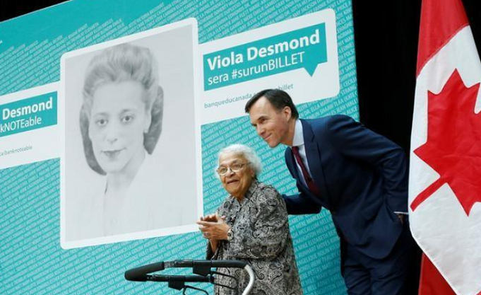 Canada's Finance Minister Morneau stands with Wanda Robson after her sister Viola Desmond was chosen to be featured on the country's new $10 bank note.