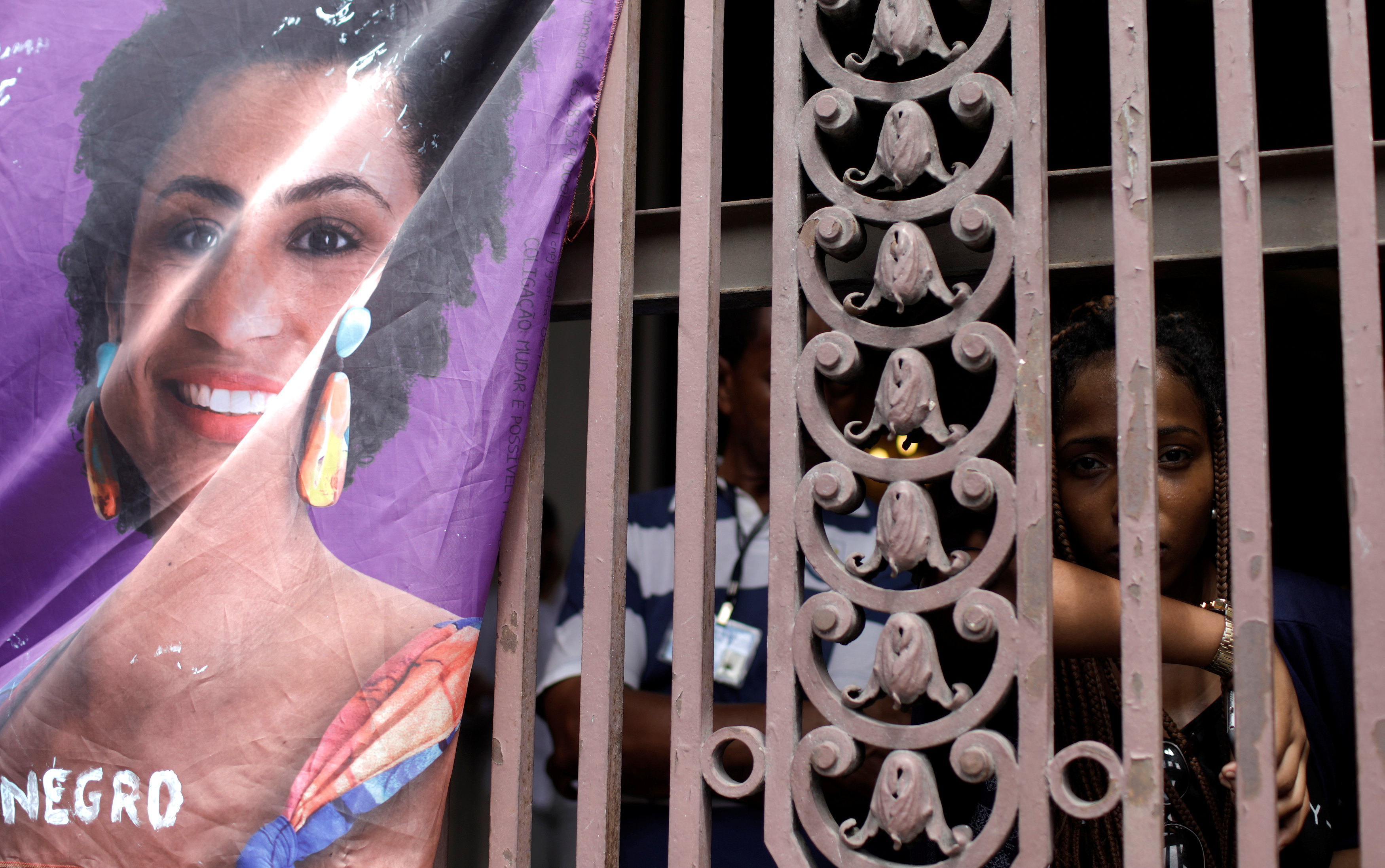 A woman reacts next to a picture of the Rio de Janeiro city councillor Marielle Franco, 38, who was shot dead, during a demonstration ahead of her wake outside the city council chamber in Rio de Janeiro, Brazil March 15, 2018.