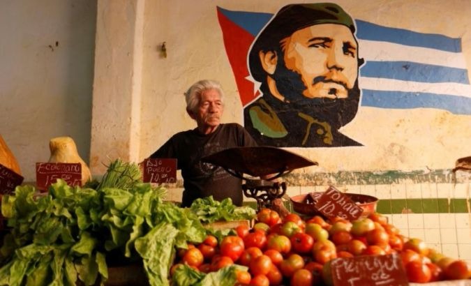 A man sells vegetables at a market in Havana, Cuba.