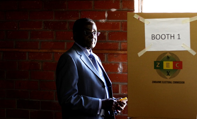 Zimbabwe's President Robert Mugabe looks on before casting his vote in Highfields outside Harare, Zimbabwe July 31, 2013.