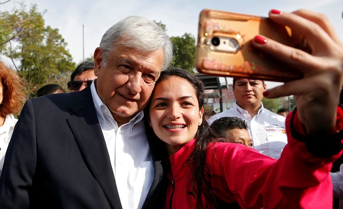Andres Manuel Lopez Obrador, candidate of the National Regeneration Movement, takes a selfie after offering a floral tribute to the 80th anniversary of the expropriation of Mexico's oil industry at Lazaro Cardenas monument in Mexico City, March 18, 2018.