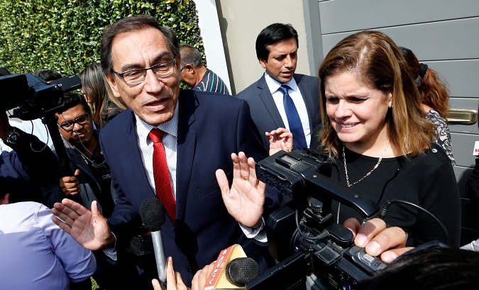 Peruvian Vice President Martin Vizcarra (L) and Mercedes Araoz talk to the press outside his house in Lima, Peru, June 8, 2016.