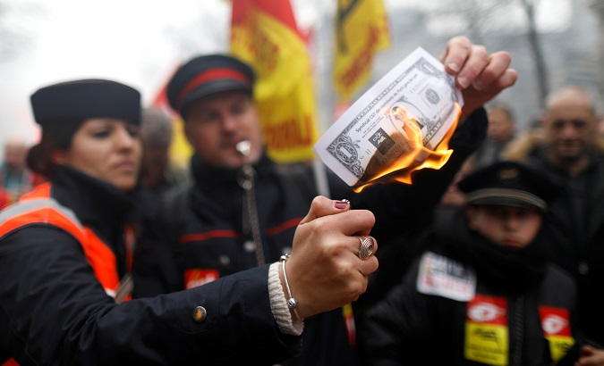Railway workers and protestors attend a demonstration during a national day of strike against reforms in Paris, France, March 22, 2018.