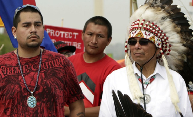 Member of Native American tribes speak to reporters during a press conference.