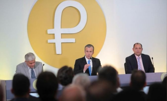 The Petro's logo is seen behind Venezuela's Vice President Tareck El Aissami (Center) as he speaks during a meeting with ministers in Caracas, Venezuela.