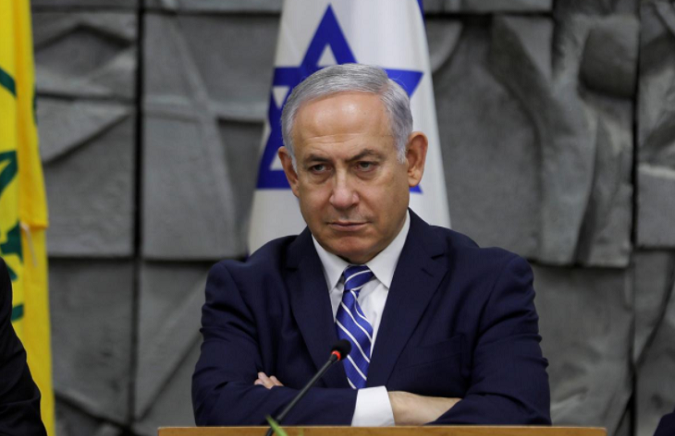 Israeli Prime Minister Benjamin Netanyahu attends the weekly cabinet meeting, convened at the Dimona municipality building in southern Israel, March 20, 2018.