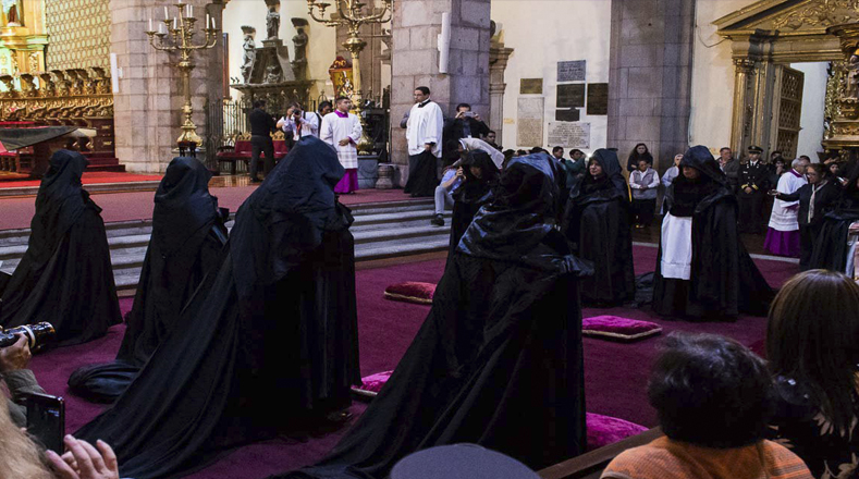 De los 28 religiosos 8 de ellos están cubiertos con ropa de color negra de aproximadamente cuatro metros de largo que representa barrer los pecados de la humanidad cuando estos recorren la Catedral.
