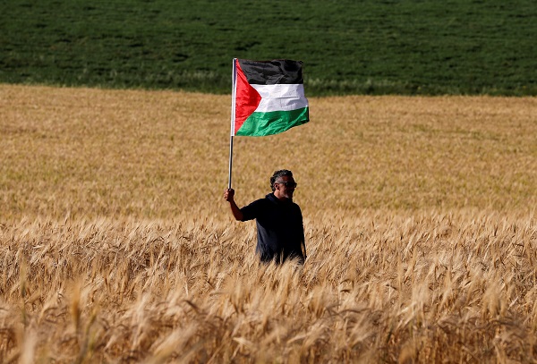 A left-wing activist takes part in a protest in solidarity with Palestinians living in Gaza, next to the Gaza-Israel border.