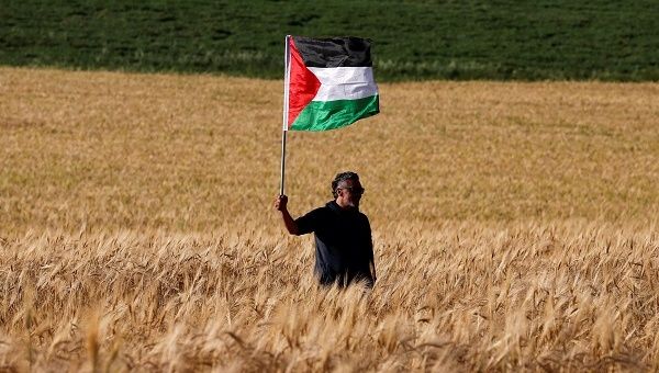 A left-wing activist takes part in a protest in solidarity with Palestinians living in Gaza, next to the Gaza-Israel border.