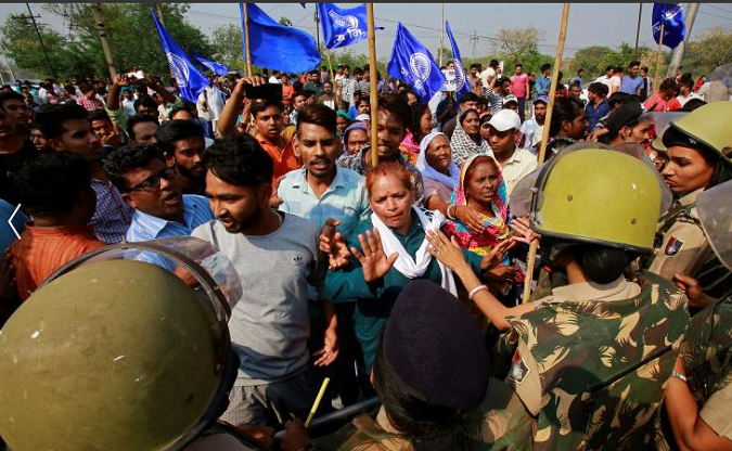 Police try to stop people belonging to the Dalit community as they take part in a protest during a nationwide strike called by Dalit organizations, April 2, 2018.