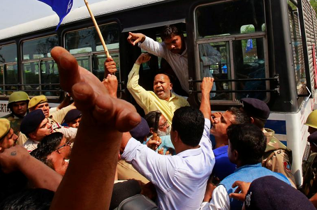 People belonging to the Dalit community shout slogans as they are detained by the police during a protest following a nationwide strike called by Dalit organizations.