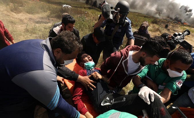Medics evacuate wounded man in Gaza.