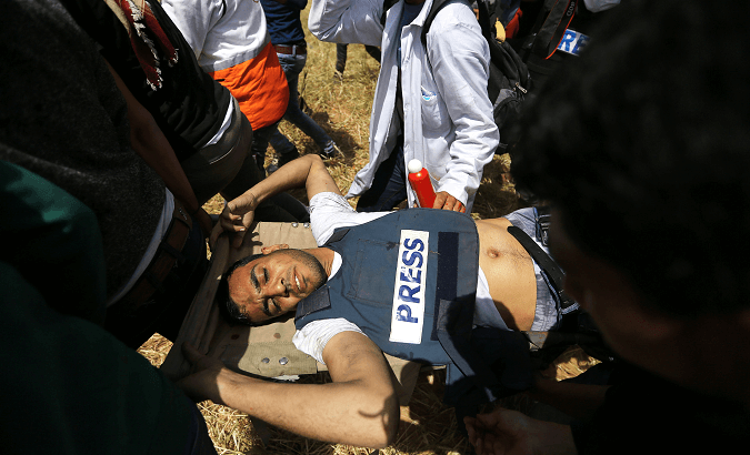 Journalist Yaser Murtaja is evacuated after being shot by an Israeli sniper.