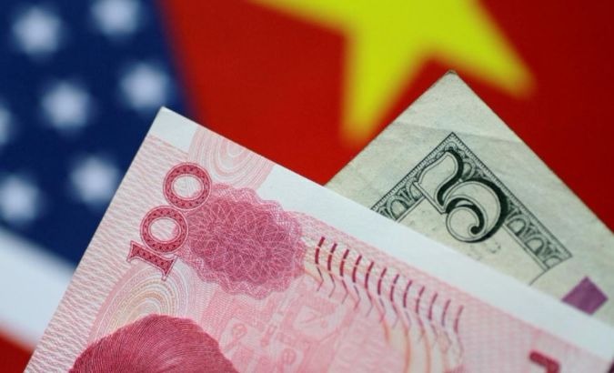 A Chinese yuan is positioned in front of a U.S. dollar.