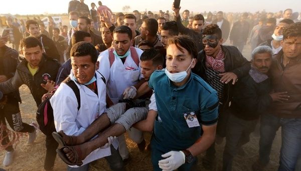 A wounded Palestinian demonstrator is evacuated after being shot by Israeli troops at a protest demanding the right to return to their homeland, Gaza April 9, 2018. 