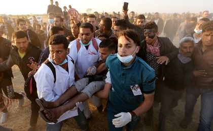 A wounded Palestinian demonstrator is evacuated after being shot by Israeli troops at a protest demanding the right to return to their homeland, Gaza April 9, 2018. 