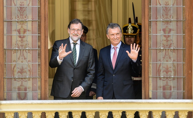 Argentine President Mauricio Macri and Spain's Prime Minister Mariano Rajoy wave from the balcony of the Casa Rosada government house, in Buenos Aires
