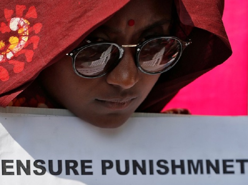  A woman holds a placard at a protest against the rape of an eight-year-old girl, in Kathua, near Jammu and a teenager in Unnao, Uttar Pradesh state, in New Delhi, India April 12, 2018. 