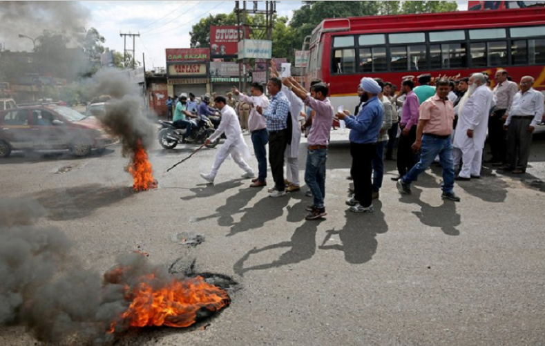 Activists of National Panther party burn tyres and shout slogans during a protest in support of various demands, including deportation of Rohingyas and Bangladeshi nationals from Jammu, and a CBI probe into the rape and murder of an eight-year-old girl in Kathua on January, Jammu April 11, 2018.