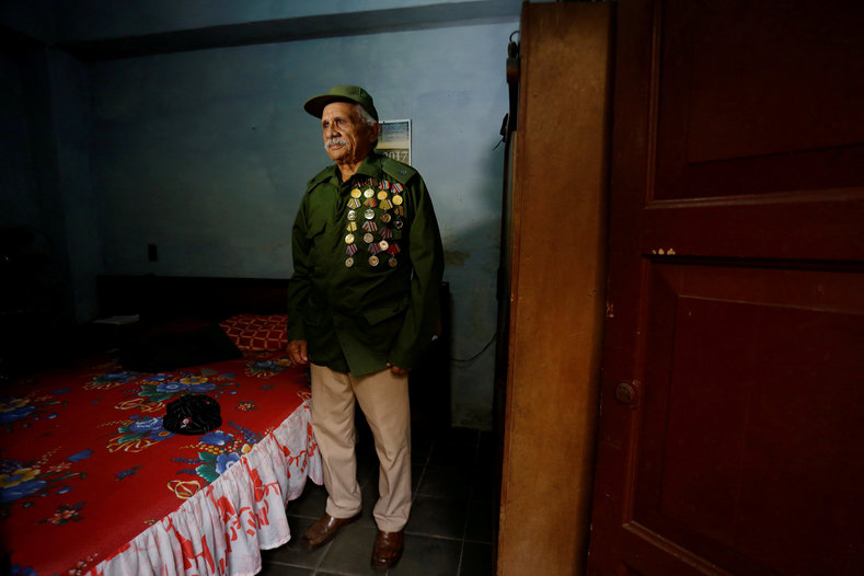 Former rebel Julio Lopez, 77, poses for a photo in his home in Santa Clara, Cuba. Illiterate when he joined the revolution, he was taught to read by Che Guevara as they camped in the jungle. The man most likely to be the next president of Cuba, Manuel Diaz-Canel, used to stop by his house to hear stories of his days in the Sierra Maestra.