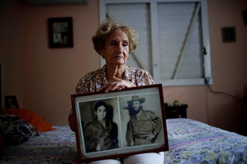 Former rebel Juana Ramirez, 81, shows a photograph of herself with her late husband and rebel fighter Luiz Perez. Fidel Castro married the couple as they fought in the Sierra Maestra.