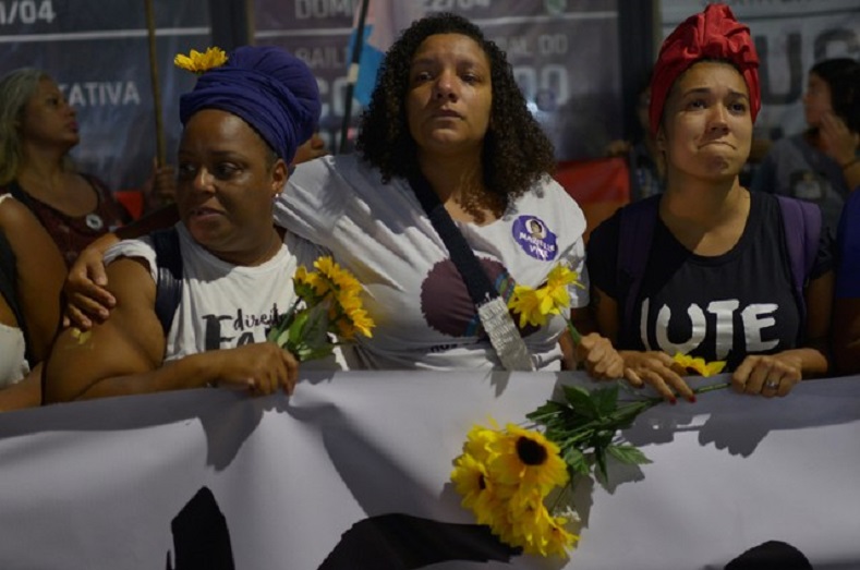  Demonstrators react as they take part in a protest against the shooting of Rio de Janeiro city councillor Marielle Franco one month after her death, in Rio de Janeiro. 