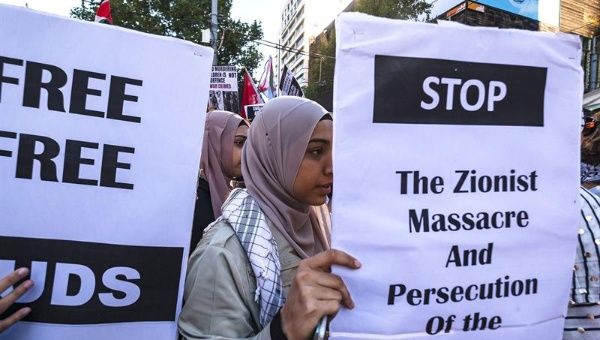 Pro-Palestine demonstrators hold signs during a rally in Melbourne, Victoria, Australia, 07 April 2018.