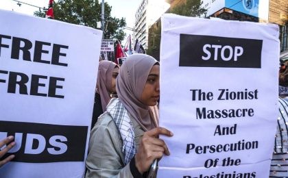 Pro-Palestine demonstrators hold signs during a rally in Melbourne, Victoria, Australia, 07 April 2018.