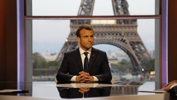 French President Emmanuel Macron poses on the TV set before an interview with French journalists at the Theatre National de Chaillot in Paris, France, April 15, 2018. 