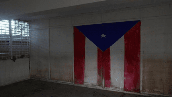 The Puerto Rican flag is seen on the wall of a class room of a shut-down elementary school, in Toa Baja, Puerto Rico February 5, 2018