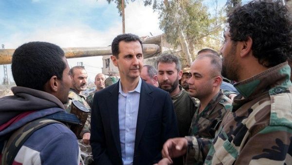Syrian President Bashar al-Assad meets with Syrian army soldiers in eastern Ghouta, Syria, March 18, 2018.
