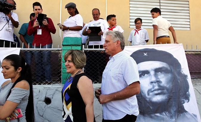 Cuba's First Vice-President Miguel Diaz-Canel and his wife stand in line before he casts his vote during an election, in Santa Clara Cuba March 11, 2018.