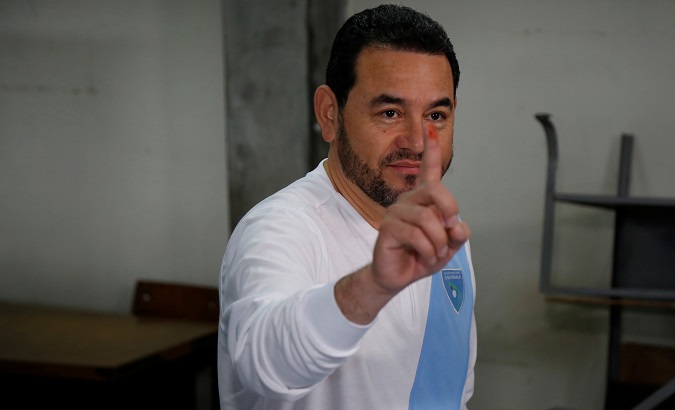 Guatemalan President Jimmy Morales shows his inked finger as he votes at a polling station during a referendum on a border dispute with Belize.