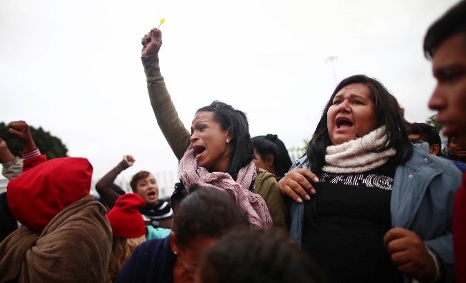 Members of the caravan cheered when the group was allowed to cross.