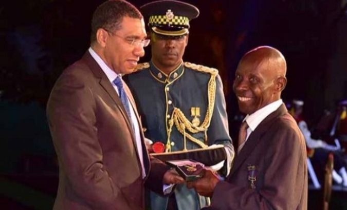 Stanley Roy Archer (Right) receives his medal from Prime Minister Andrew Holness.