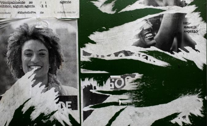 Pictures of Marielle Franco are seen where she was assassinated in Rio de Janeiro.
