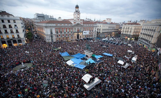 Demonstrators gather and shout slogans in Madrid's famous landmark Puerta del Sol, against politicians, bankers and authorities' handling of the economic crisis May 18, 2011.