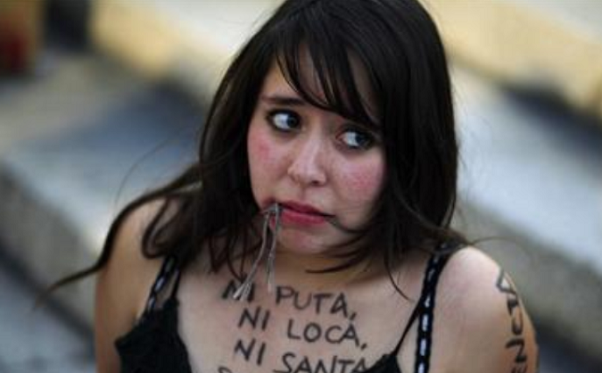 A woman pretends to be gagged while taking part in a protest during International Women's Day in Mexico City in this March 8, 2011.