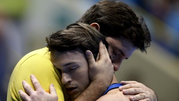 Fernando de Carvalho Lopes (L), who trained Olympic silver medalist Diego Hypolito (R), has denied sexual assault.