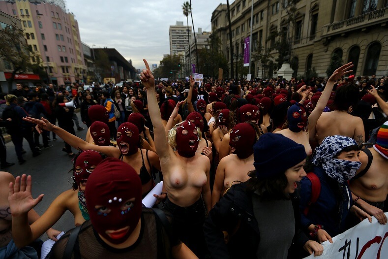 Other marched topless in a statement against sexual abuse.