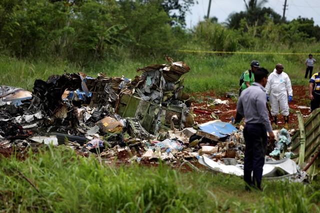 Rescuers work on the wreckage of a Boeing 737 plane that crashed in Boyeros, 12 miles south of Havana.