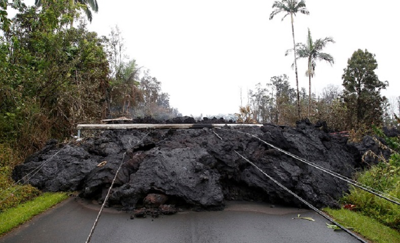 Lava and downed power lines block a road in the Leilani Estates subdivision during ongoing eruptions.