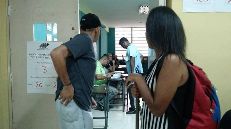 Venezuelans await their turn to vote at a polling booth in Caracas' Andres Bello High School. 