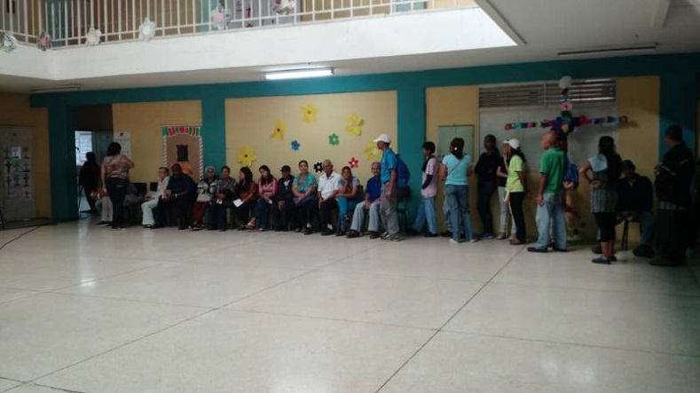 Venezuelans await their turn to vote at a polling booth in Caracas' Andres Bello High School. 