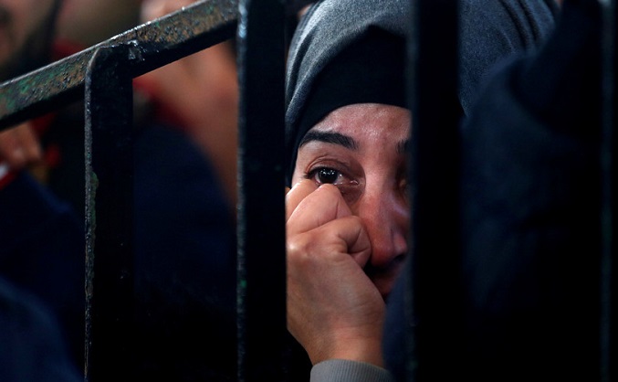 A Palestinian woman in the southern Gaza Strip waits for a travel permit to cross into Egypt through the Rafah border crossing after it was opened by Egyptian authorities for humanitarian cases.