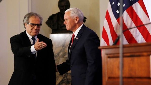 OAS Secretary General Almagro (L) greets U.S. Vice President Pence Mike Pence (R) as he arrives to address the OAS on May 7.