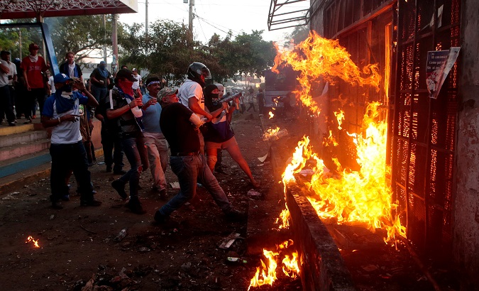 Protesters burn a public radio station in Managua, Nicaragua, May 30, 2018.